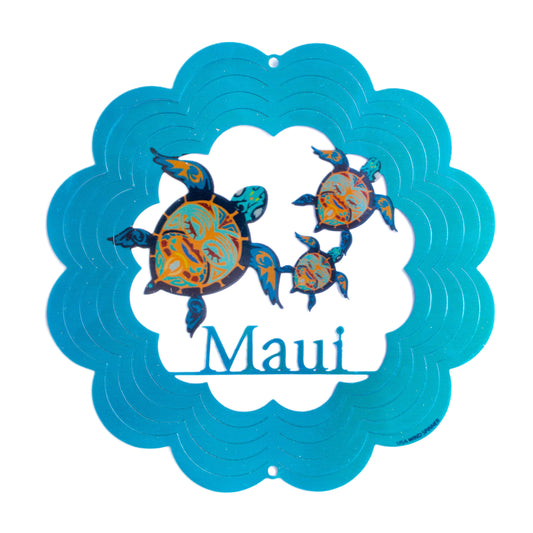 Decorative wind spinner with turtles and 'Maui' text on a blue scalloped border.